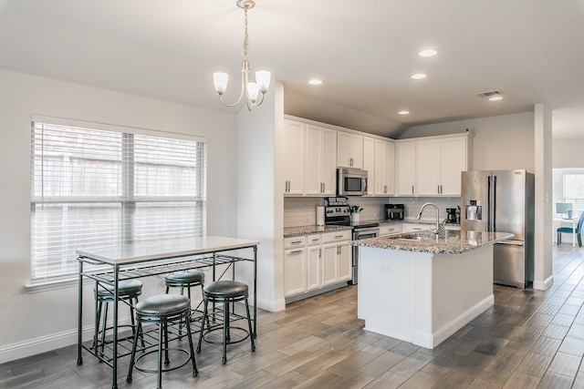 kitchen featuring wood finished floors, a sink, and appliances with stainless steel finishes