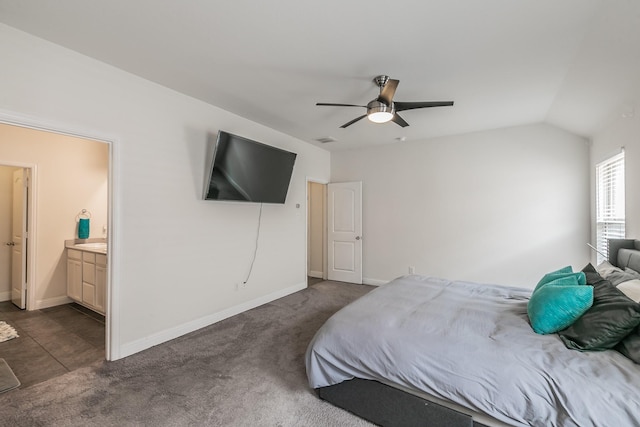 bedroom with dark carpet, visible vents, connected bathroom, baseboards, and ceiling fan