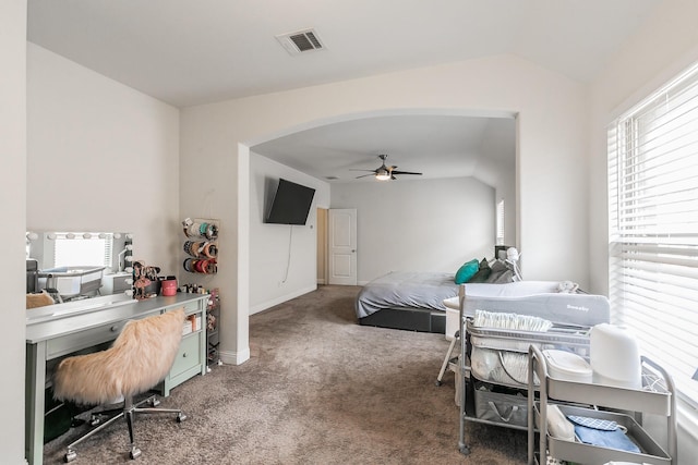 carpeted bedroom with lofted ceiling, multiple windows, and visible vents