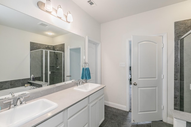 bathroom with a shower stall, visible vents, and a sink