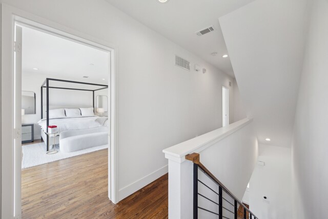 4980 Fuqua St, Dallas, TX 75206 - corridor with wood finished floors, an upstairs landing, baseboards, and visible vents