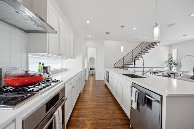 4980 Fuqua St, Dallas, TX 75206 - kitchen with white cabinetry, light countertops, range hood, a sink, and appliances with stainless steel finishes