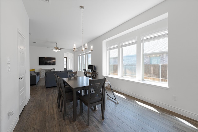 dining room with baseboards, dark wood-style flooring, visible vents, and ceiling fan with notable chandelier