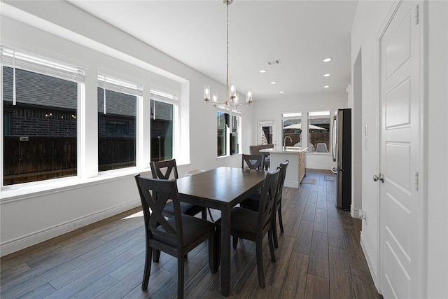 dining room with visible vents, baseboards, recessed lighting, dark wood finished floors, and an inviting chandelier