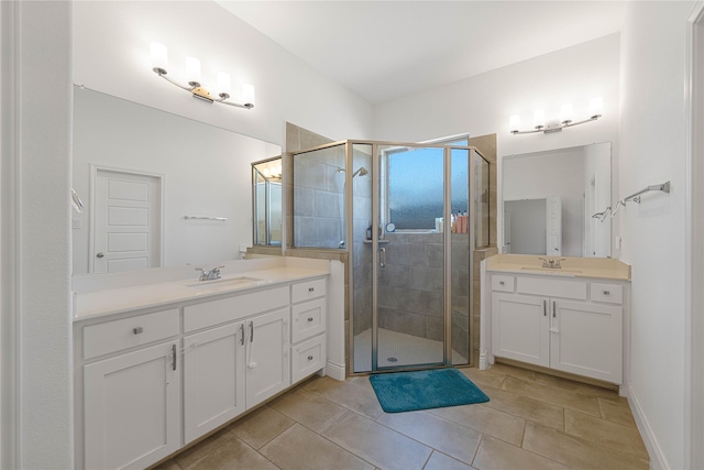 bathroom featuring two vanities, a sink, and a stall shower