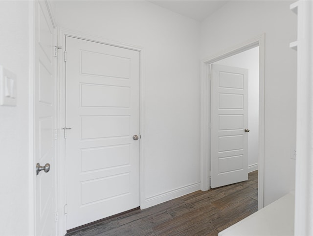 bedroom featuring baseboards and dark wood-type flooring