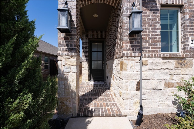 doorway to property with stone siding