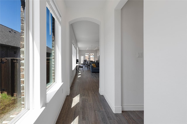 corridor featuring arched walkways