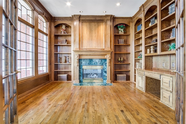 5816 Forest Highlands Dr, Fort Worth, TX 76132 - unfurnished living room featuring a premium fireplace, recessed lighting, light wood finished floors, and built in shelves