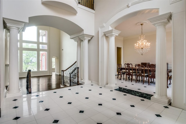 5816 Forest Highlands Dr, Fort Worth, TX 76132 - tiled foyer entrance with arched walkways, ornate columns, a high ceiling, and crown molding