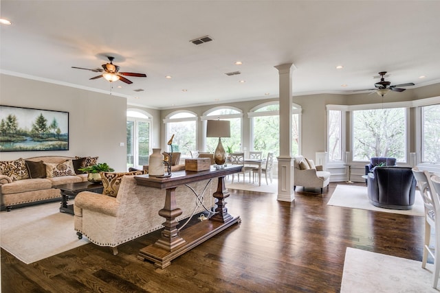 5816 Forest Highlands Dr, Fort Worth, TX 76132 - living room with ornate columns, dark wood-style flooring, visible vents, and a ceiling fan