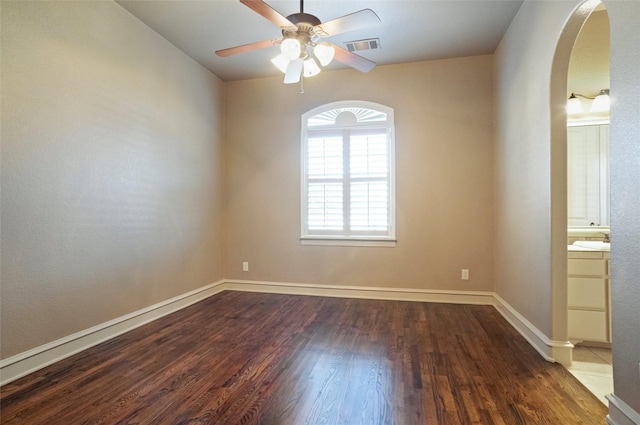 1304 Rollie Michael Ln, Fort Worth, TX 76179 - unfurnished room featuring a ceiling fan, visible vents, arched walkways, wood finished floors, and baseboards