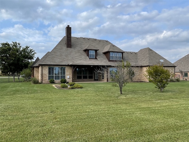 1304 Rollie Michael Ln, Fort Worth, TX 76179 - back of house featuring a lawn, brick siding, a chimney, and a shingled roof
