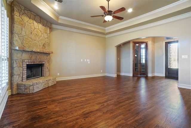 1304 Rollie Michael Ln, Fort Worth, TX 76179 - unfurnished living room with arched walkways, a fireplace, a tray ceiling, and a wealth of natural light