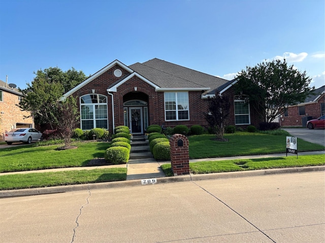 209 Timberbluff Ln, Murphy, TX 75094 - view of front of house featuring roof with shingles, a front lawn, and brick siding