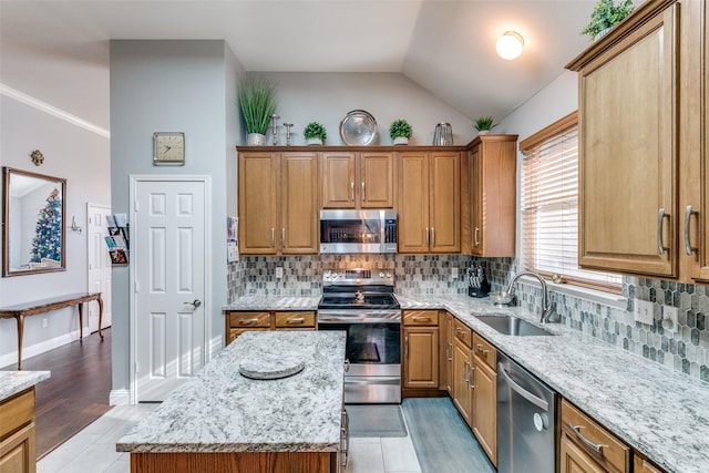 209 Timberbluff Ln, Murphy, TX 75094 - kitchen featuring light stone counters, a sink, brown cabinetry, stainless steel appliances, and tasteful backsplash