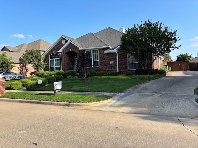 209 Timberbluff Ln, Murphy, TX 75094 - view of front facade featuring concrete driveway, a chimney, a front yard, and brick siding