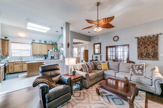 209 Timberbluff Ln, Murphy, TX 75094 - living area featuring light wood-style floors, ceiling fan, and vaulted ceiling