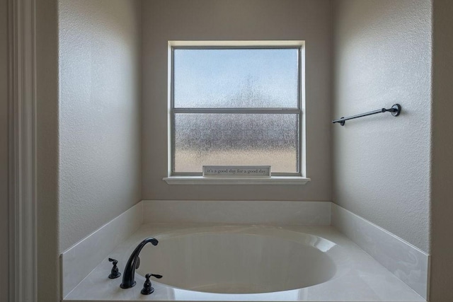 1233 War Admiral Dr, Terrell, TX 75160 - bathroom with a textured wall and a bath