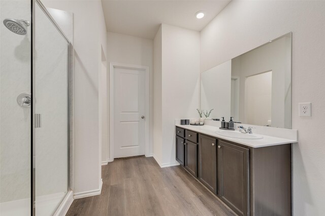 3213 Grimaldo Dr, Mesquite, TX 75126 - bathroom with wood finished floors, a shower stall, vanity, and baseboards