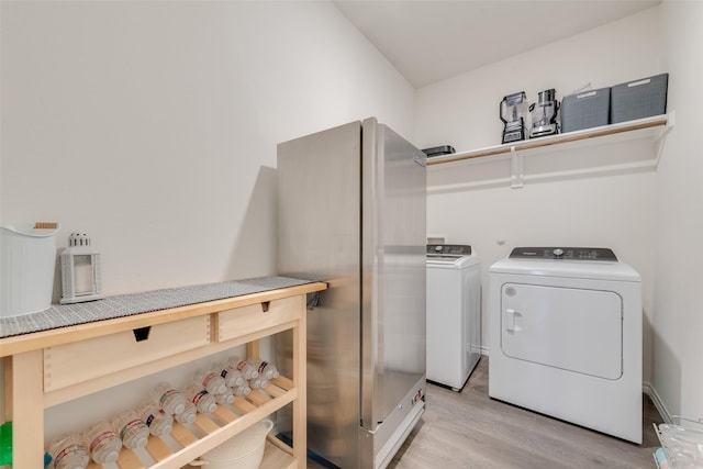 3213 Grimaldo Dr, Mesquite, TX 75126 - laundry area with light wood-style flooring and independent washer and dryer