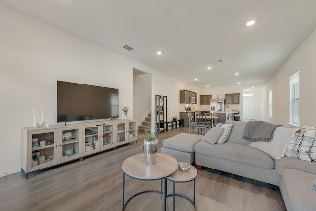 3213 Grimaldo Dr, Mesquite, TX 75126 - living room with wood finished floors, stairway, and recessed lighting