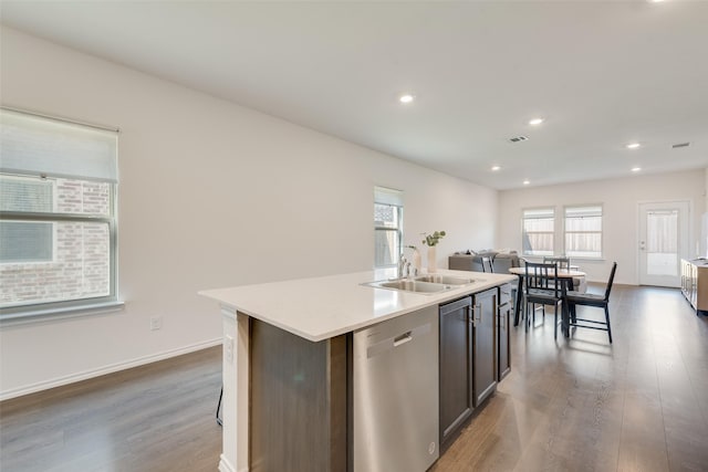 3213 Grimaldo Dr, Mesquite, TX 75126 - kitchen featuring dishwasher, a sink, open floor plan, wood finished floors, and a kitchen island with sink