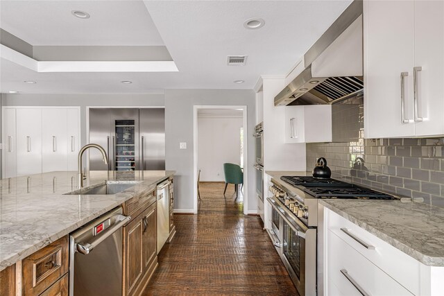 5230 Boca Raton Dr, Dallas, TX 75229 - kitchen featuring range hood, a sink, visible vents, appliances with stainless steel finishes, and brown cabinetry