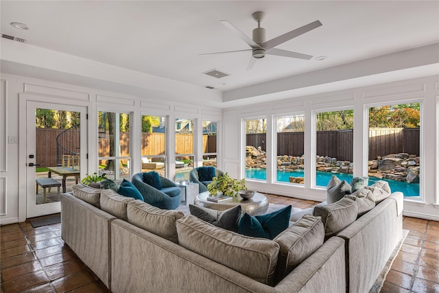 5230 Boca Raton Dr, Dallas, TX 75229 - living room with a decorative wall, visible vents, and ceiling fan