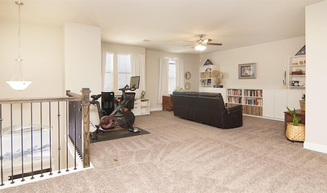 carpeted living room with baseboards and ceiling fan