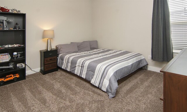 carpeted bedroom with baseboards