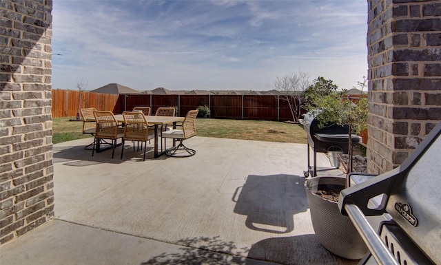 view of patio featuring a fenced backyard and outdoor dining area