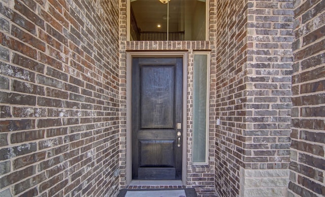 property entrance with brick siding