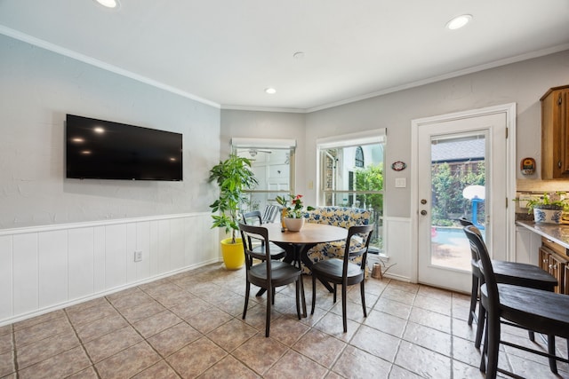 5835 Mapleshade Ln, Dallas, TX 75252 - dining room featuring crown molding, recessed lighting, a wainscoted wall, light tile patterned flooring, and a decorative wall