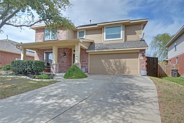 view of front of house featuring roof with shingles, fence, an attached garage, driveway, and brick siding