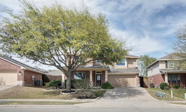 view of front facade featuring fence, a garage, solar panels, brick siding, and driveway