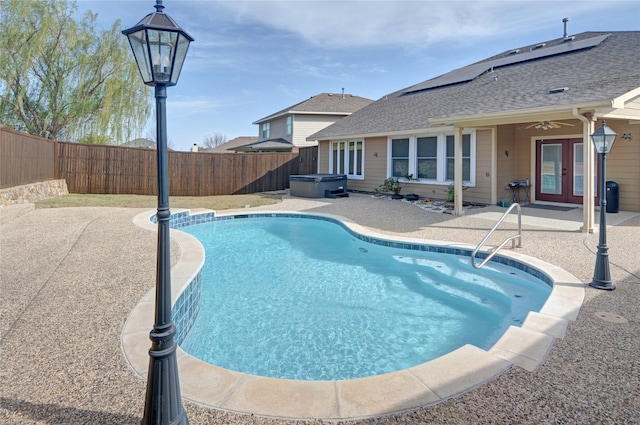 view of pool featuring ceiling fan, a fenced backyard, a hot tub, french doors, and a patio area
