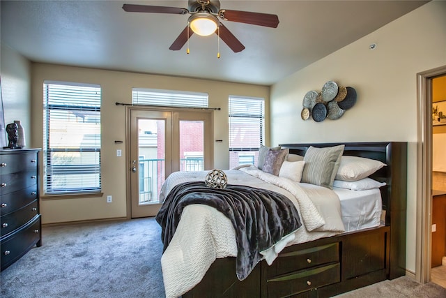 bedroom with multiple windows, carpet floors, a ceiling fan, and access to outside