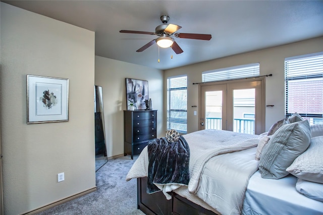 bedroom with baseboards, access to exterior, a ceiling fan, and light colored carpet