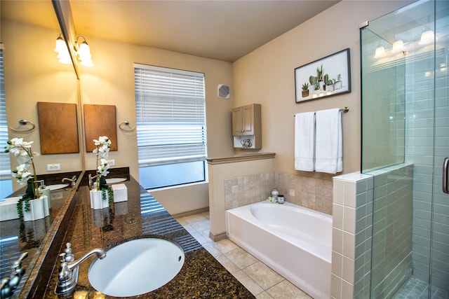 full bathroom with a shower stall, a garden tub, a sink, double vanity, and tile patterned flooring