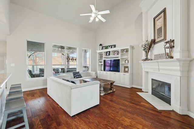 820 Clearlake Dr, Prosper, TX 75078 - living area with high vaulted ceiling, a fireplace, dark wood finished floors, ceiling fan, and baseboards