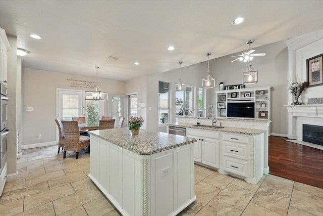 820 Clearlake Dr, Prosper, TX 75078 - kitchen featuring a center island with sink, a sink, ceiling fan, healthy amount of natural light, and recessed lighting