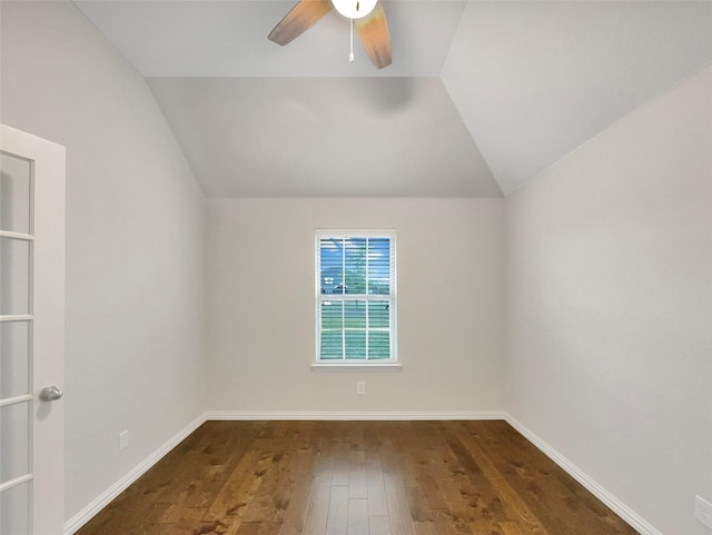 additional living space with baseboards, vaulted ceiling, a ceiling fan, and hardwood / wood-style floors