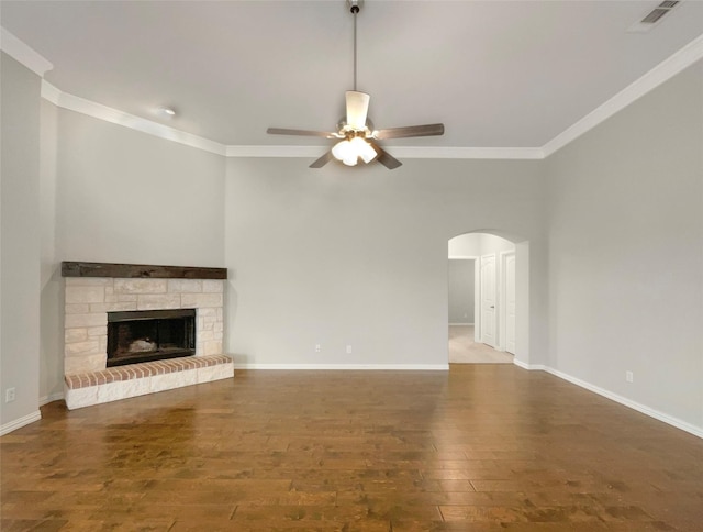 unfurnished living room with a ceiling fan, wood finished floors, crown molding, and visible vents