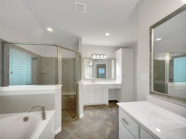 bathroom with vanity, recessed lighting, a stall shower, a garden tub, and visible vents