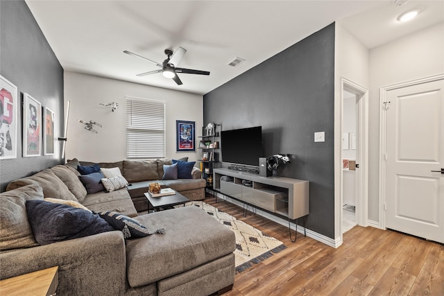 living area with ceiling fan, baseboards, light wood-style floors, and visible vents