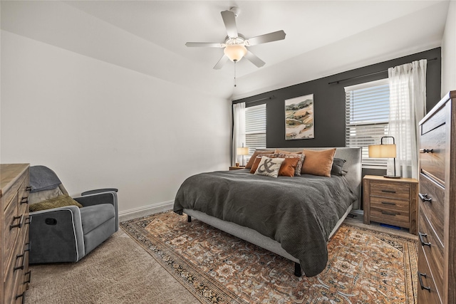 bedroom featuring baseboards, a ceiling fan, and carpet