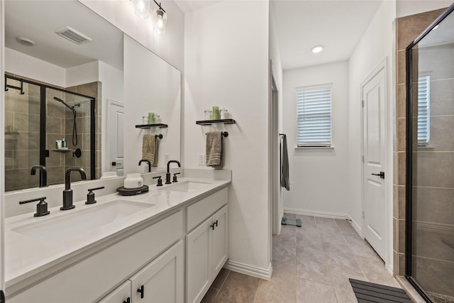 full bathroom featuring a shower stall, baseboards, a sink, and visible vents