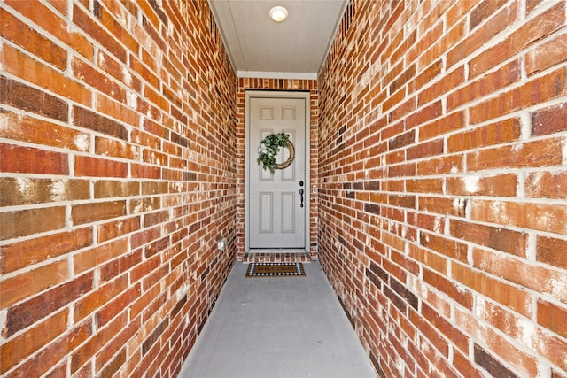 property entrance featuring brick siding