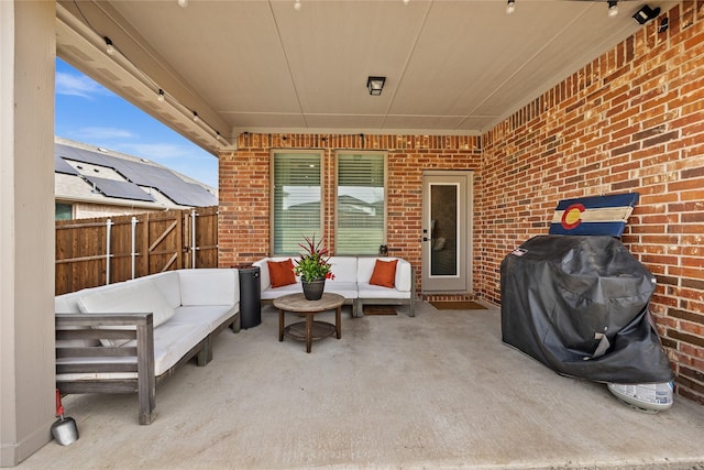 view of patio with outdoor lounge area and fence